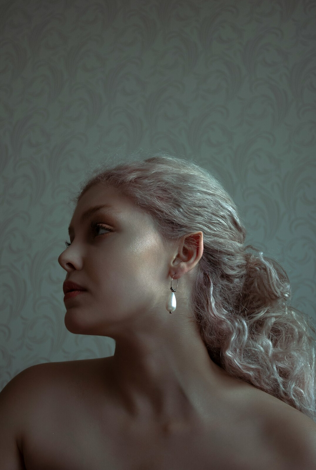Portrait of an elegant senior woman with silver hair and earrings