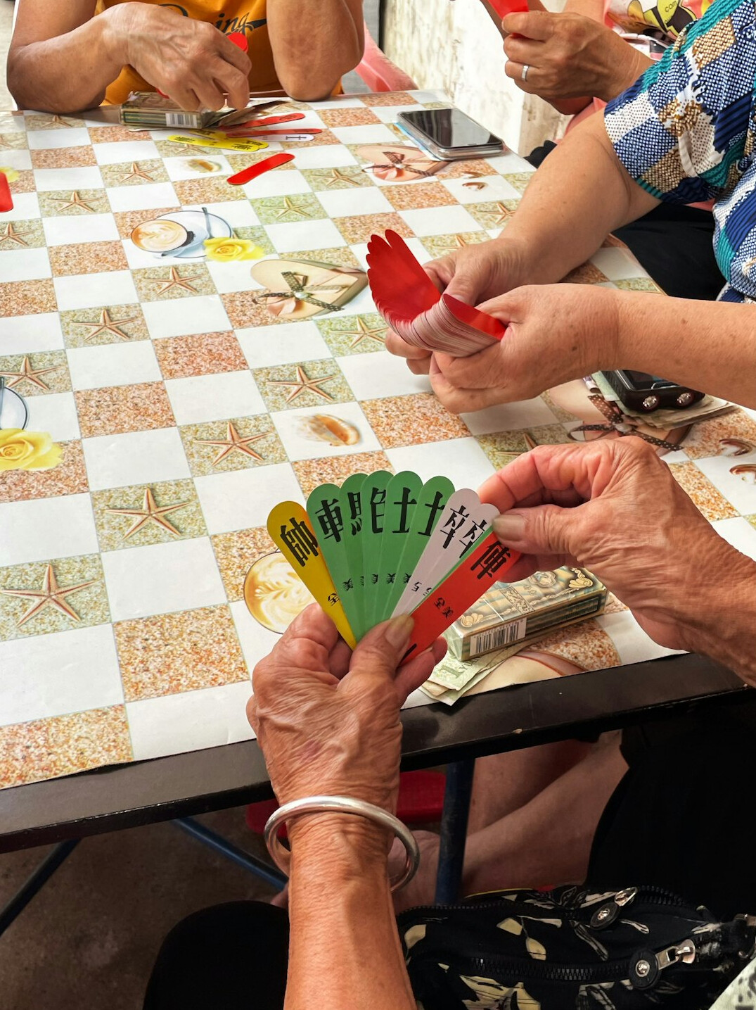 elderly group playing cards